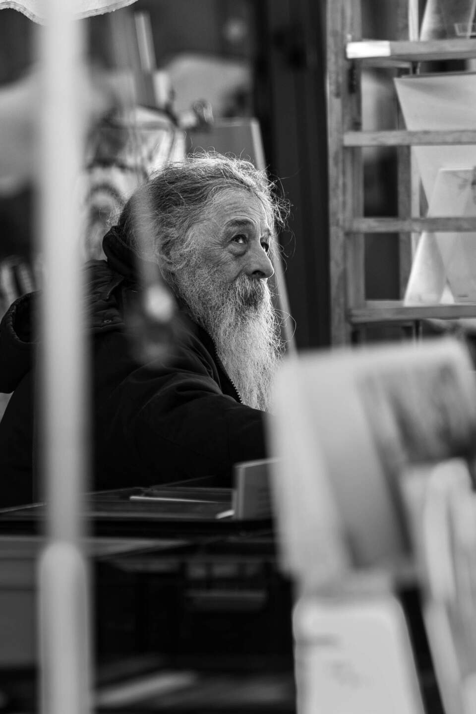 Elderly man looking into the distance at a flea market