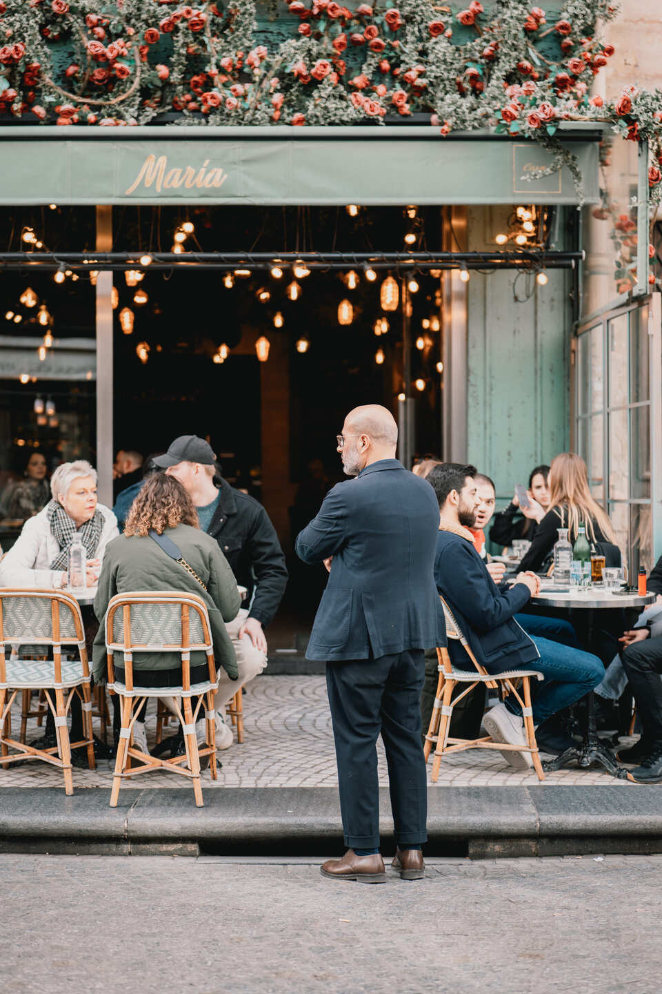 Man in front of a restaurant watching passersby